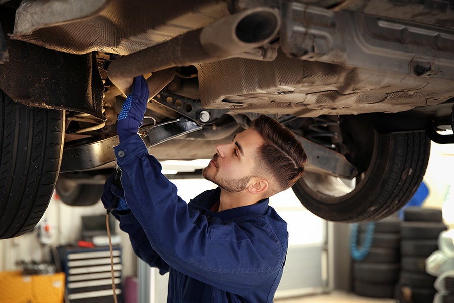 Technician working on servicing of a car